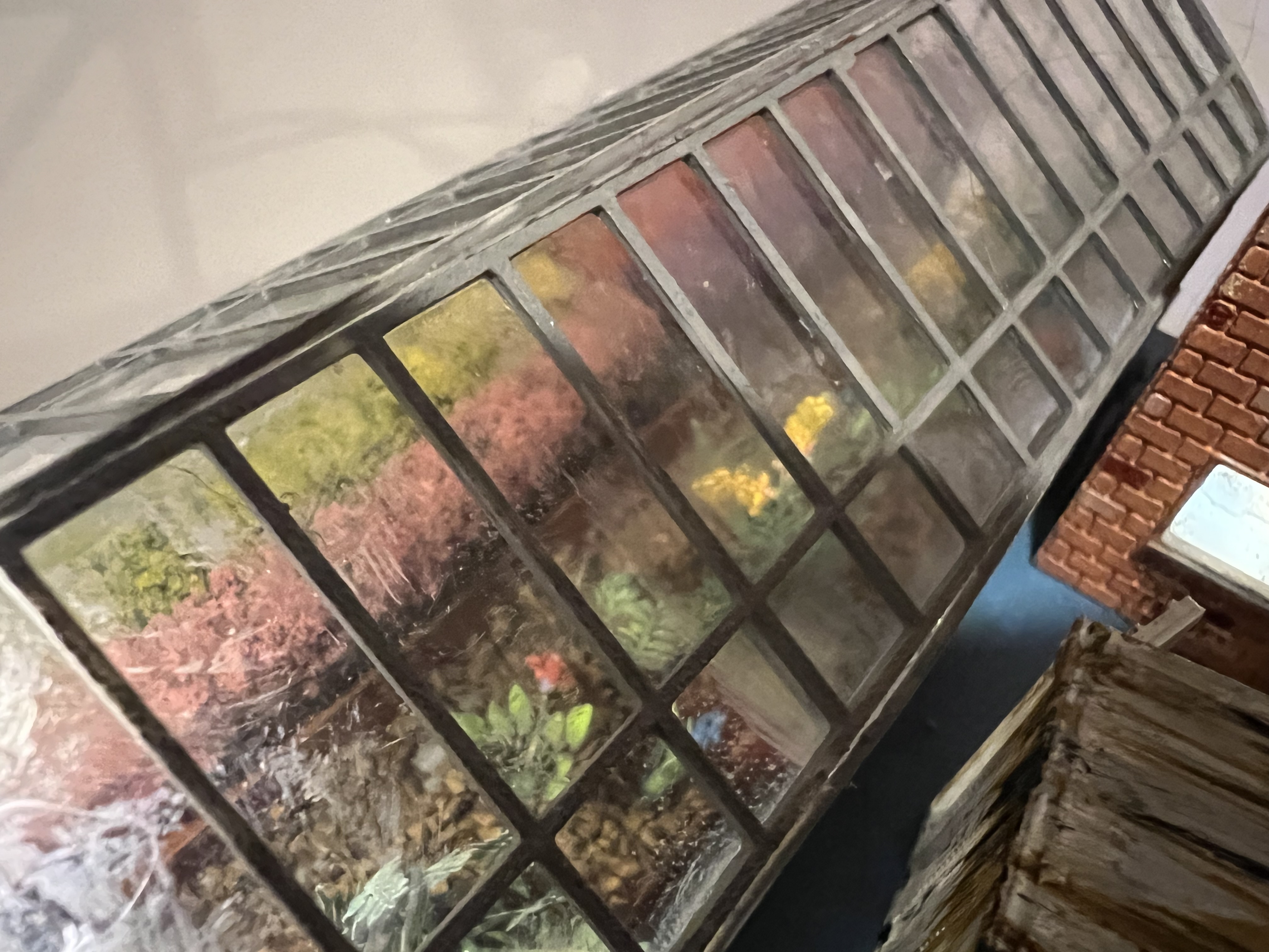 A second view into the greenhouse, showing the dirt texture and planting beds.