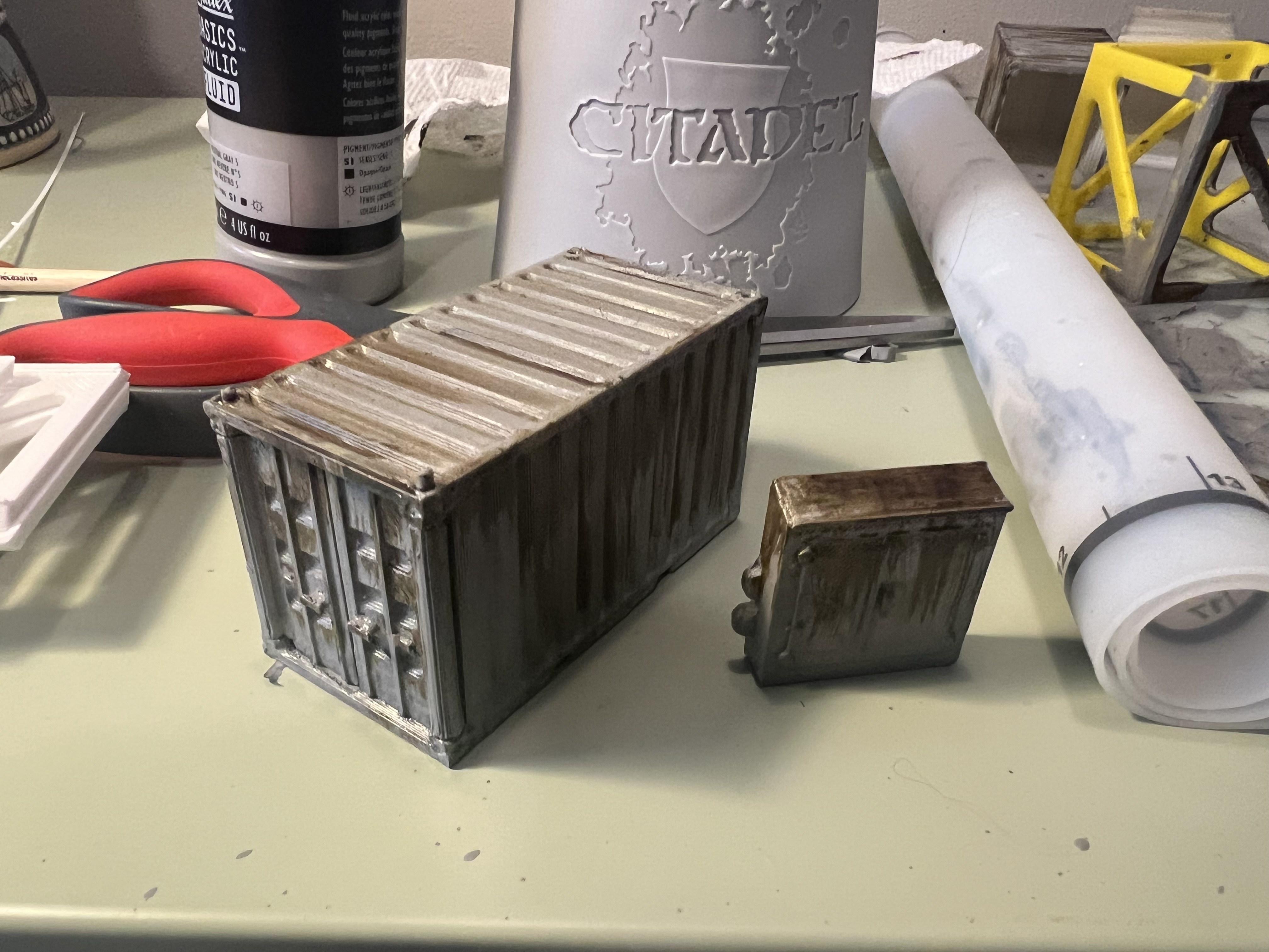 A finished crate with convincing weathered, rusted paint.