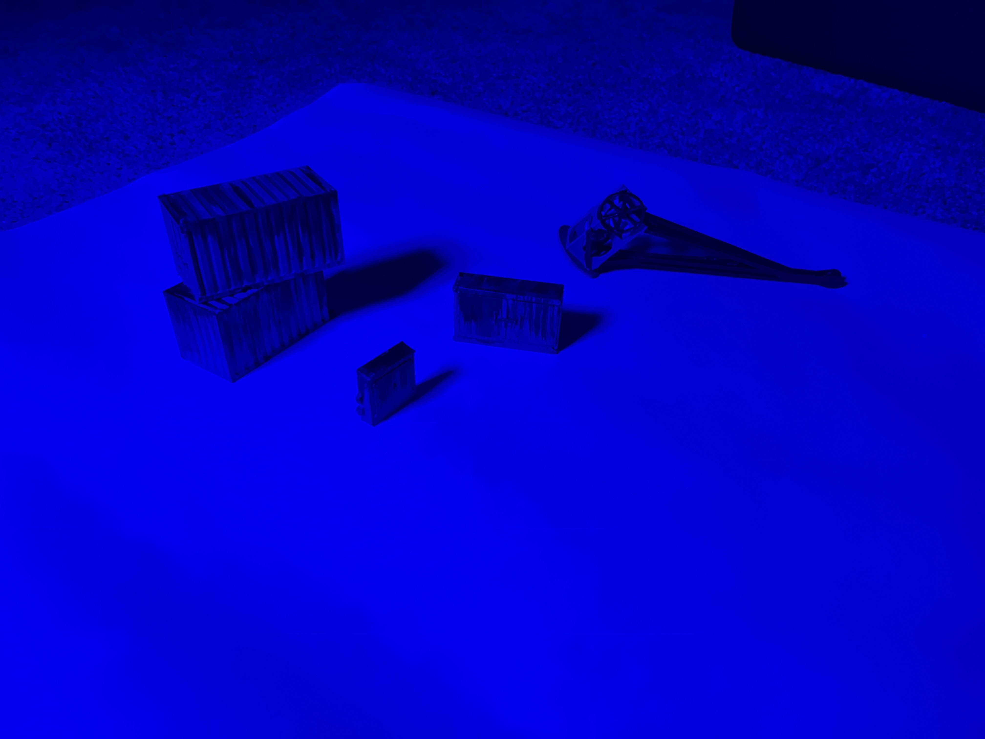 The same test pieces lit blue to simulate night.